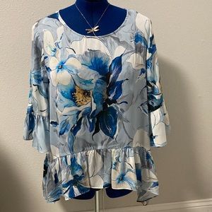 New without tags Karen Kane floral blouse with shark bite hem.